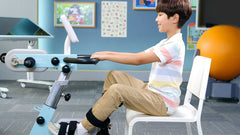 Child using CycleMotus A4K rehab trainer for arm and leg movement therapy